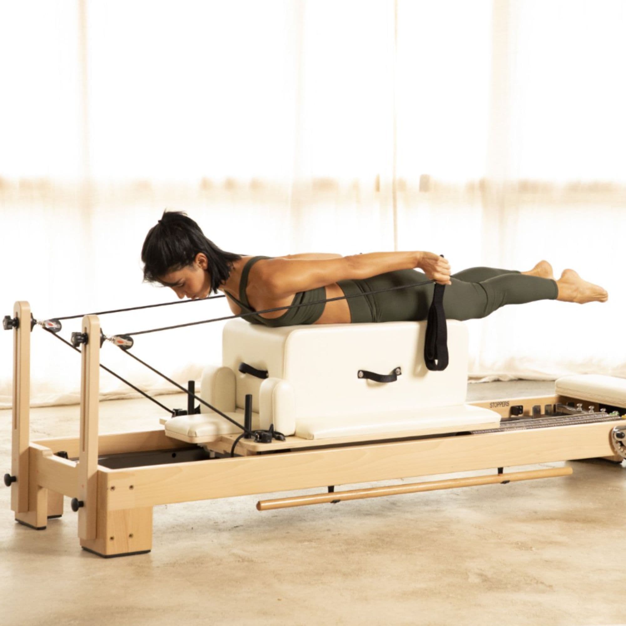 Elina Pilates Wooden Reformer Ligno Side View Of A Woman Demonstrating A Long Box Exercise And A Resistance Strap