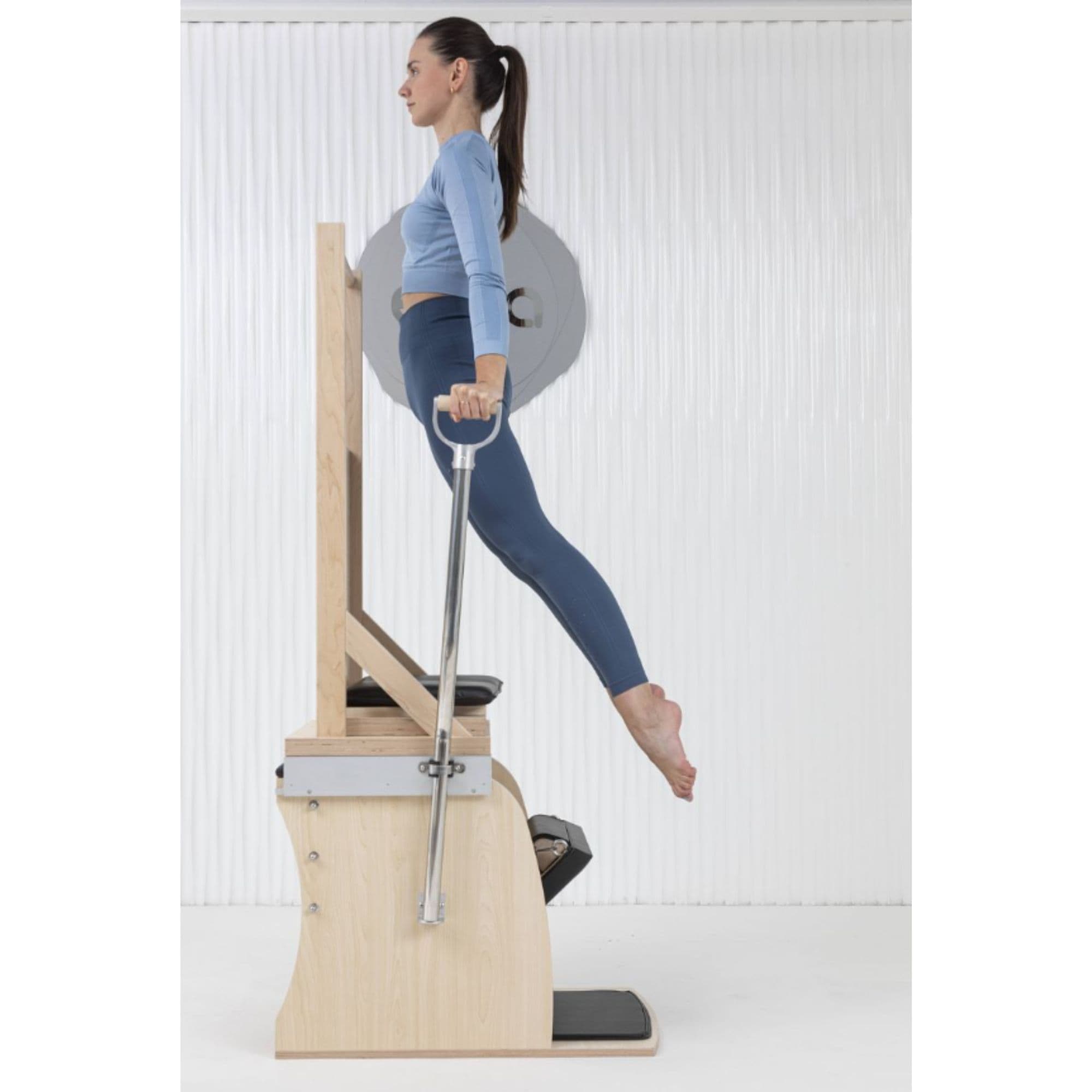 Elina Pilates Wunda Electric Chair Side View Of A Woman Demonstrating A Body Lift Exercise