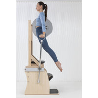 Thumbnail for Elina Pilates Wunda Electric Chair Side View Of A Woman Demonstrating A Body Lift Exercise