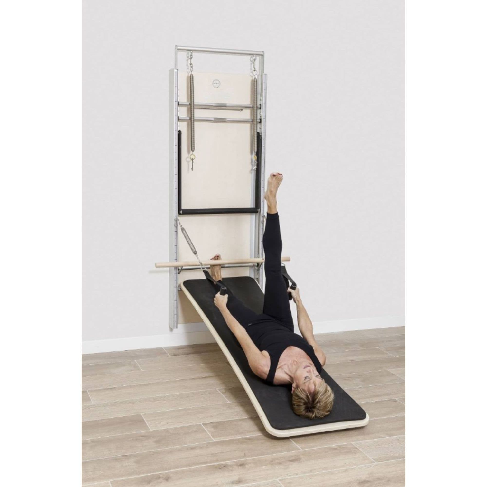 Elina Pillates ONNE Wall Board System With A Woman Performing Exercise Using A Band
