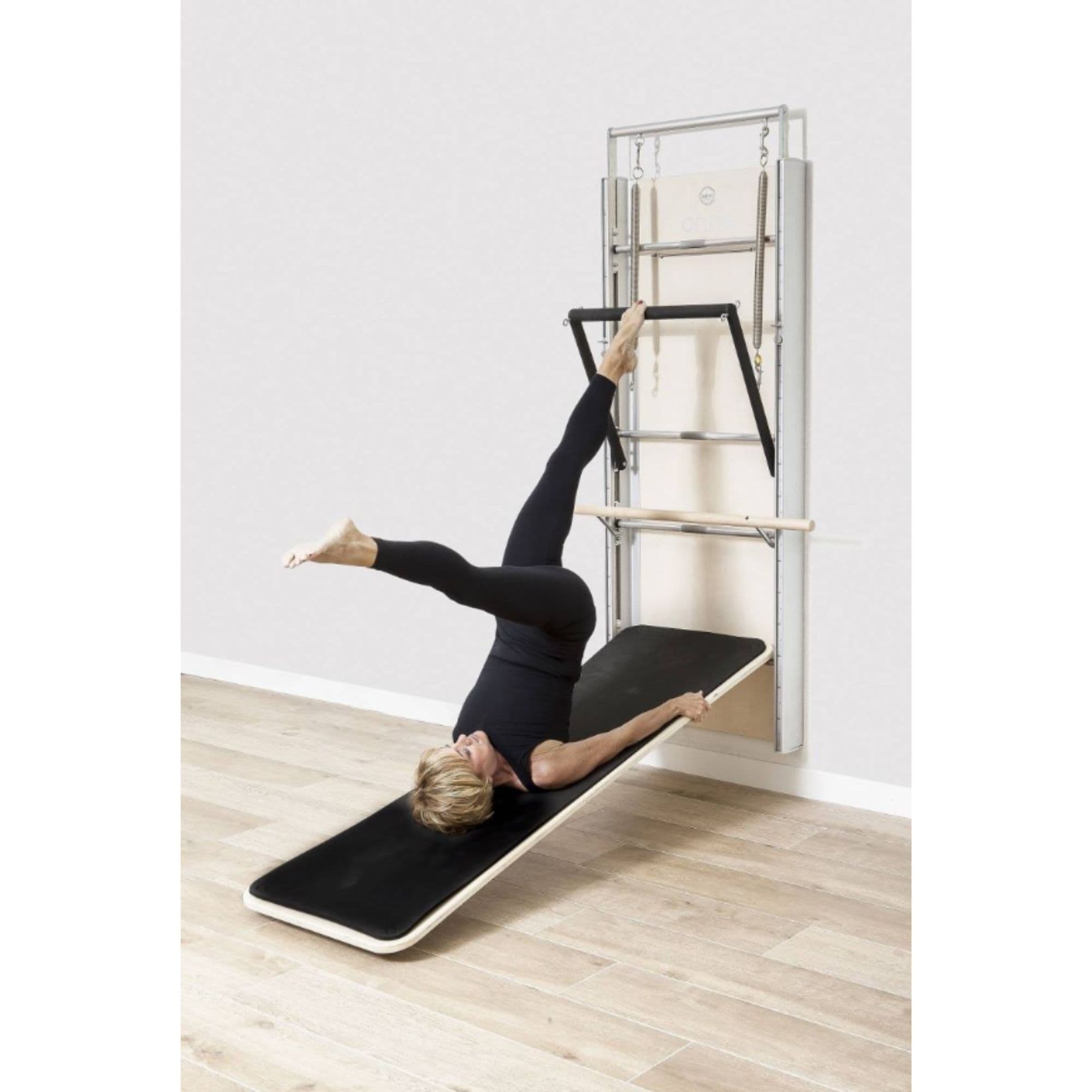 Elina Wall Board ONNE With A Woman Performing Exercise While Left Leg On The Footbar