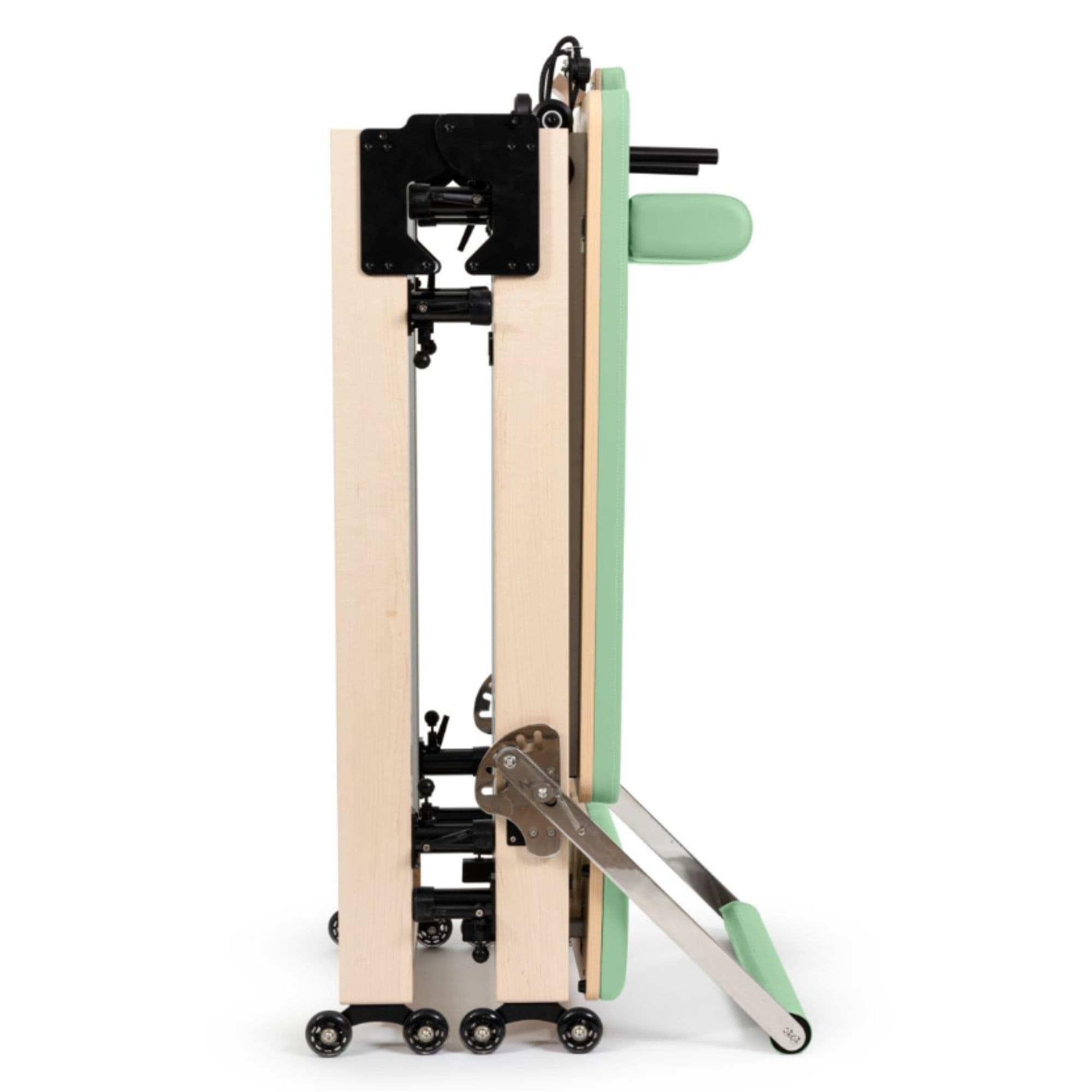 Home Foldable Reformer Green Variant Side View Showing Space-Saving Folded Configuration On White Background