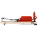 Home Vertial Pilates Reformer Side View With Jump Board Attachment And Box On White Background