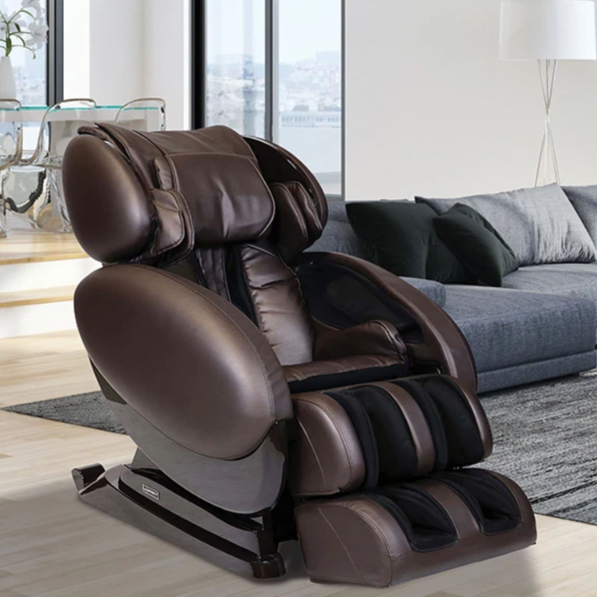 IT-8500 Massage Chair CPO Brown Variant Angled View With Couch In Modern Home Setting