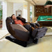 Infinity Imperial Massage Chair Certified Pre-Owned Dark Front Angled View Of A Man Relaxing In A Modern Recreation Room