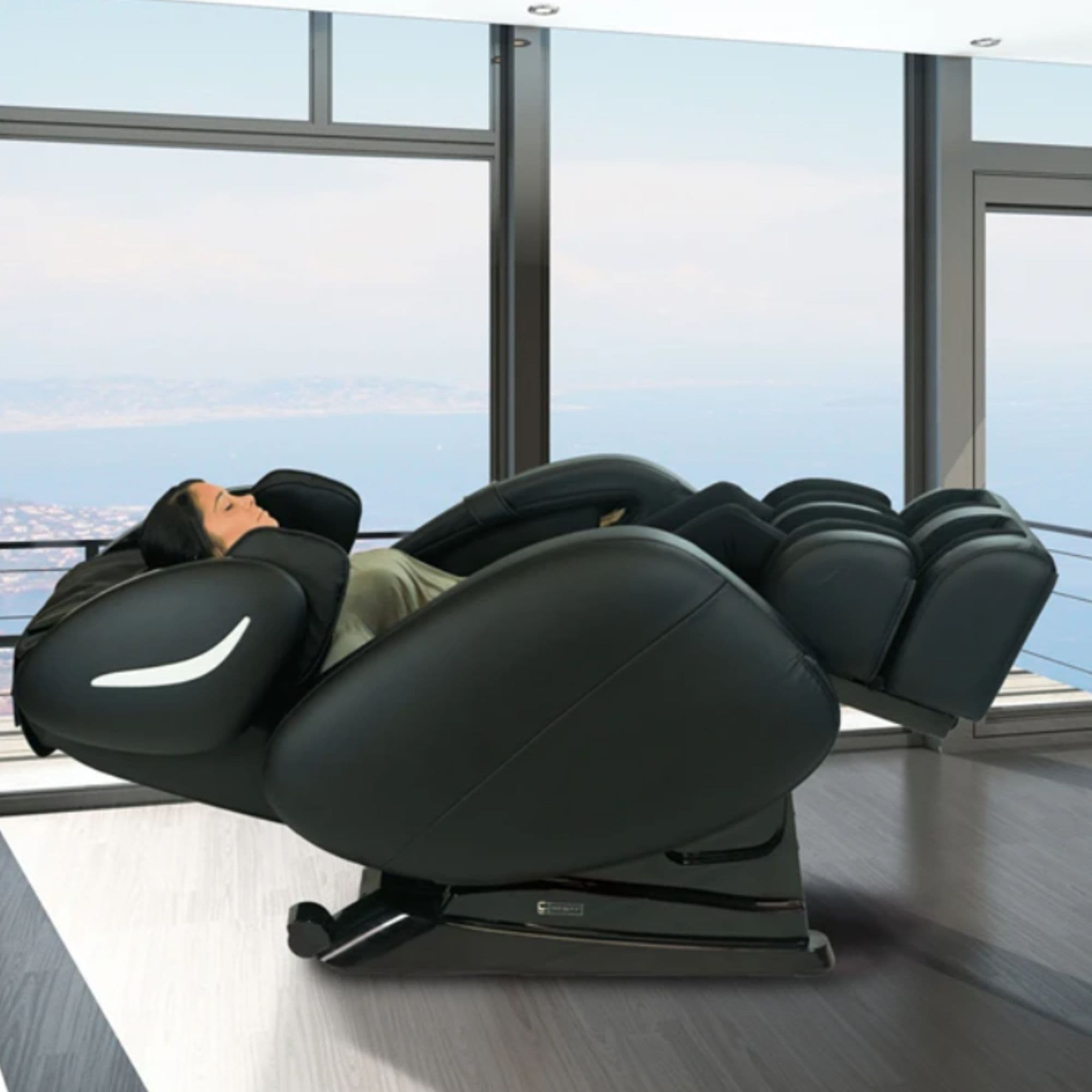 Infinity Smart Chair X3 Massage Chair Black Variant Side View Showing A Woman Relaxing On The Massage Chair With Glass Wall In Background