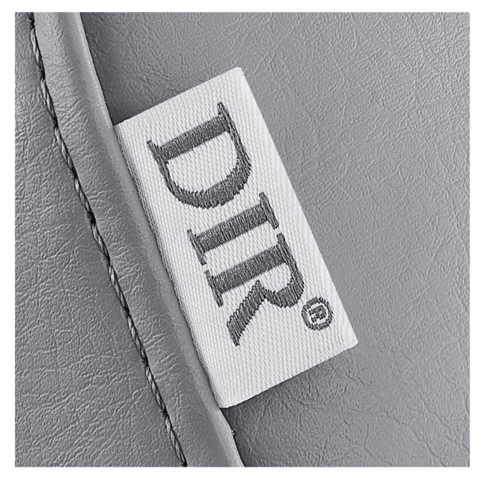 Ink OB 3-Motors Gyno Chair with Stirrups - OB GYN Close-Up View Of Gray Upholstery With Brand Name