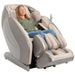 Kyota Hatsumei M900 4D AI Massage Chair Gray Tan Variant Front Angled View With A Woman Relaxing On White Background