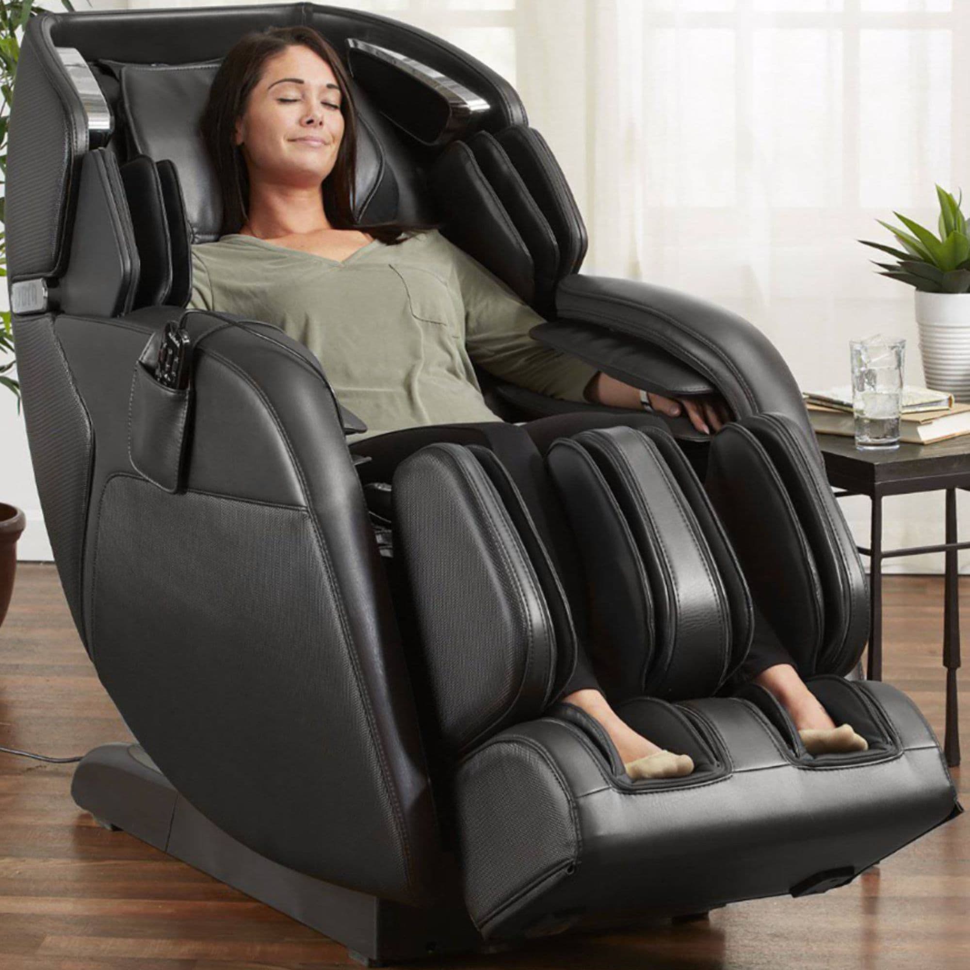 Kyota Kenko M673 Massage Chair Certified Pre-Owned Front Angle View With Woman Relaxing In Living Area