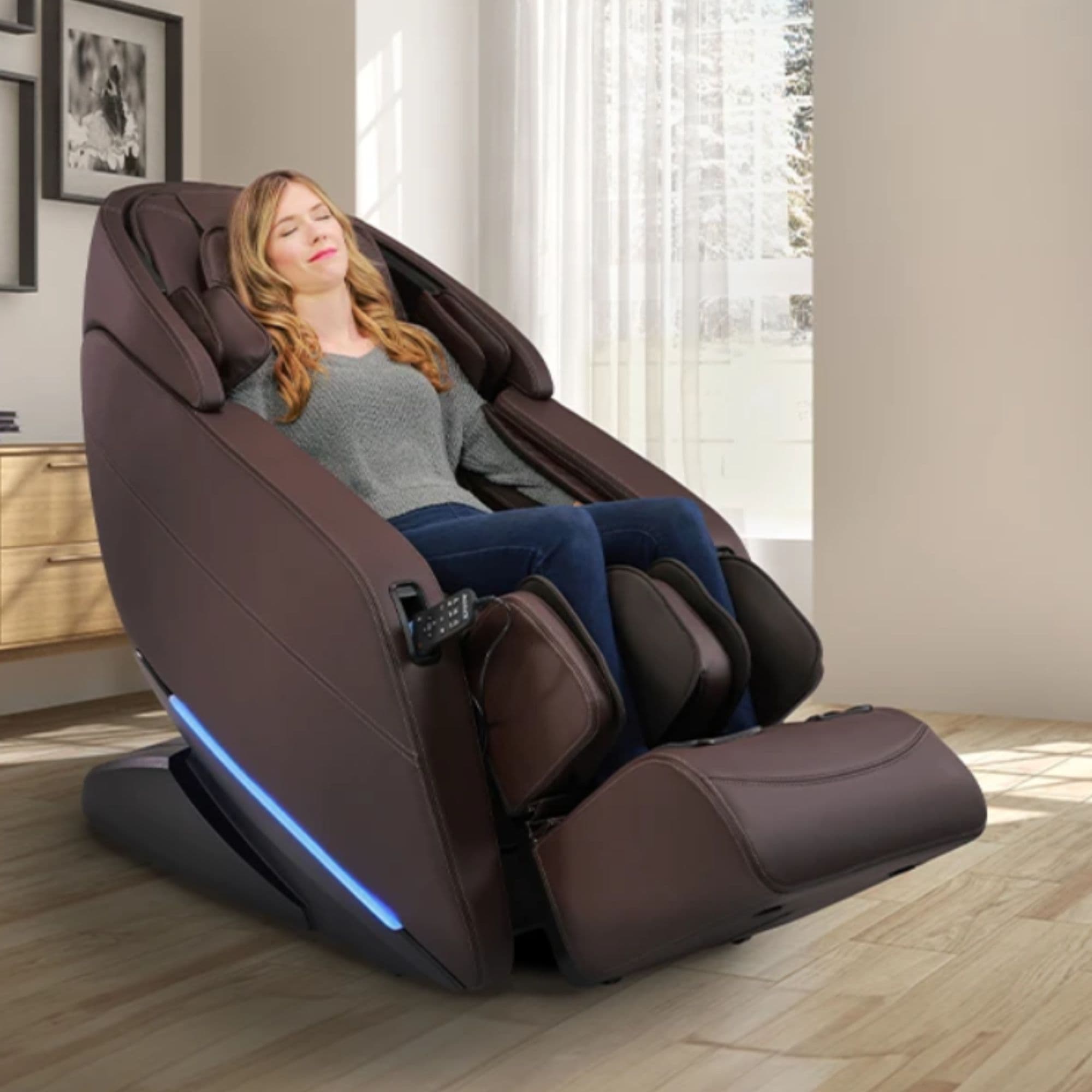 Kyota Yugana M780 4D Massage Chair Brown Variant Front Angled View Of A Woman Relaxing Near Large Windows With White Curtains
