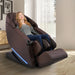 Kyota Yugana M780 4D Massage Chair Brown Variant Front Angled View Of A Woman Relaxing Near Large Windows With White Curtains
