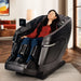Kyota Zenyu M338 Massage Chair Lifestyle Front Angled View Of A Woman Relaxing In A Modern Living Room