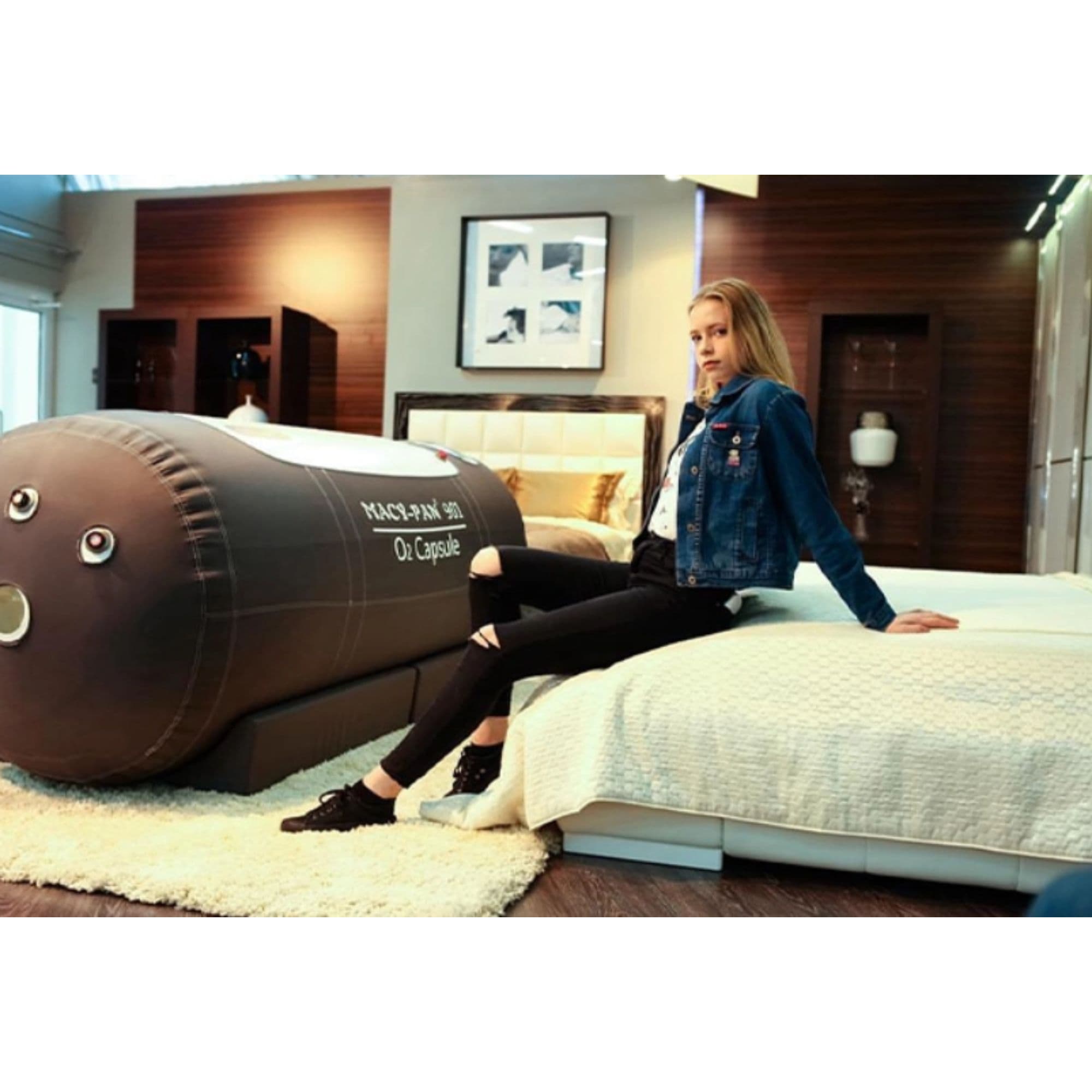 Macy-Pan ST901 Large Soft-Shell Hyperbaric Chamber Side View With Woman Sitting On Bed In Modern Bedroom