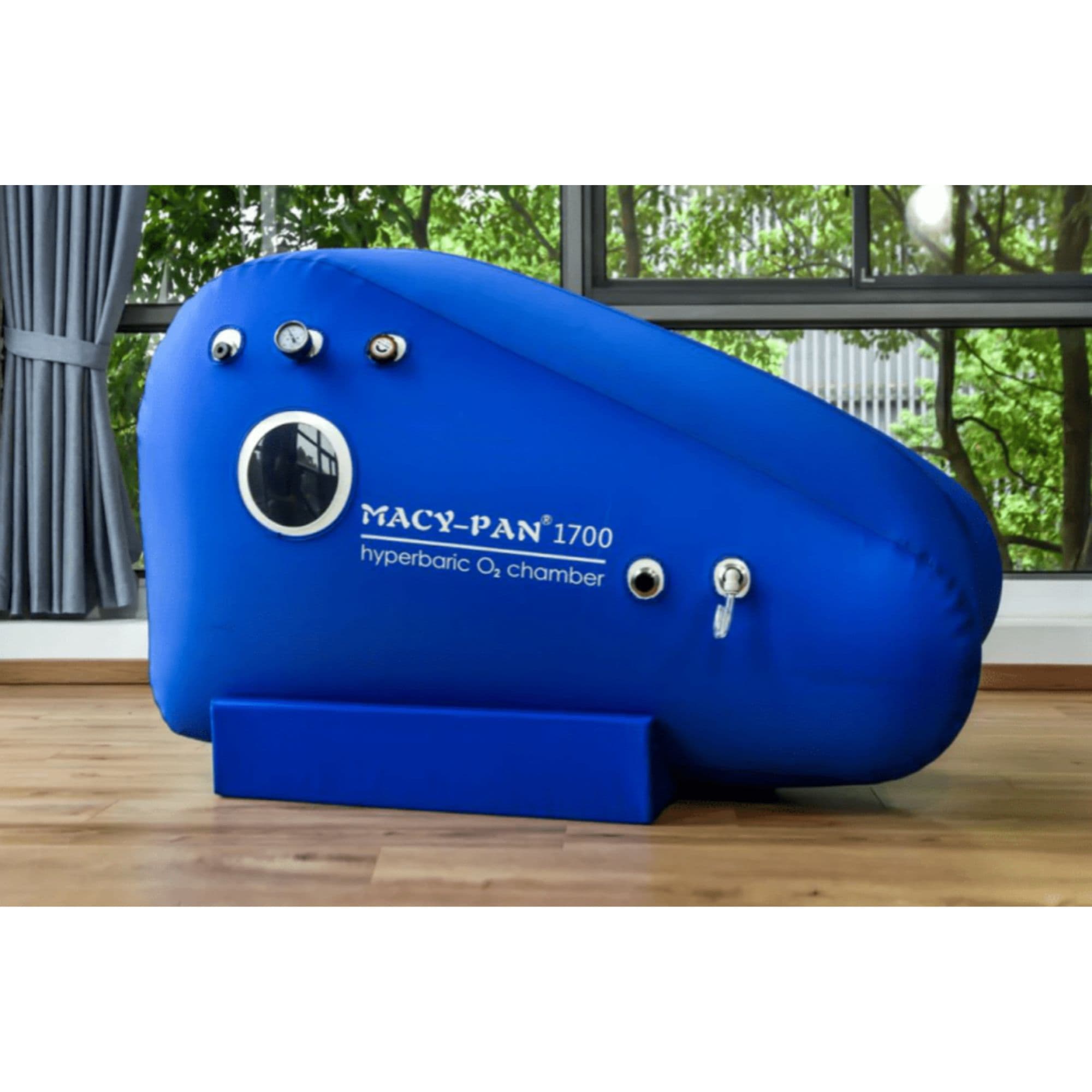 Macy Pan ST1700 Portable Sitting Hyperbaric Chamber Side View By Large Windows With Greenery Background