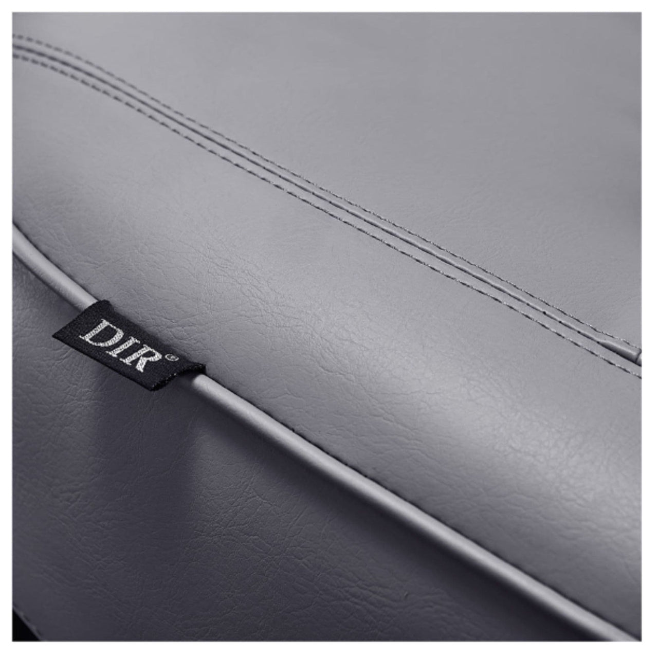 Maximus Reclining Salon Shampoo Bed Close-Up View Of Gray Upholstery With Brand Name