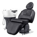 Maximus Spa Reclining Shampoo Bed with Rotating Seat Black Angled Front View Beside White Sink On White Background