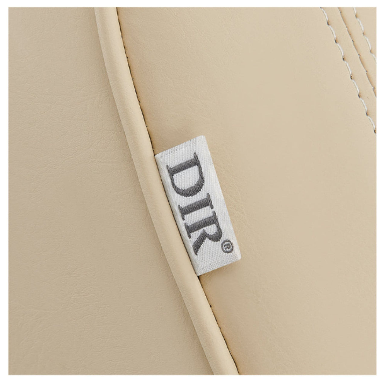 Maximus Spa Reclining Shampoo Bed with Rotating Seat Close-Up View Of Beige Upholstery With Brand Name