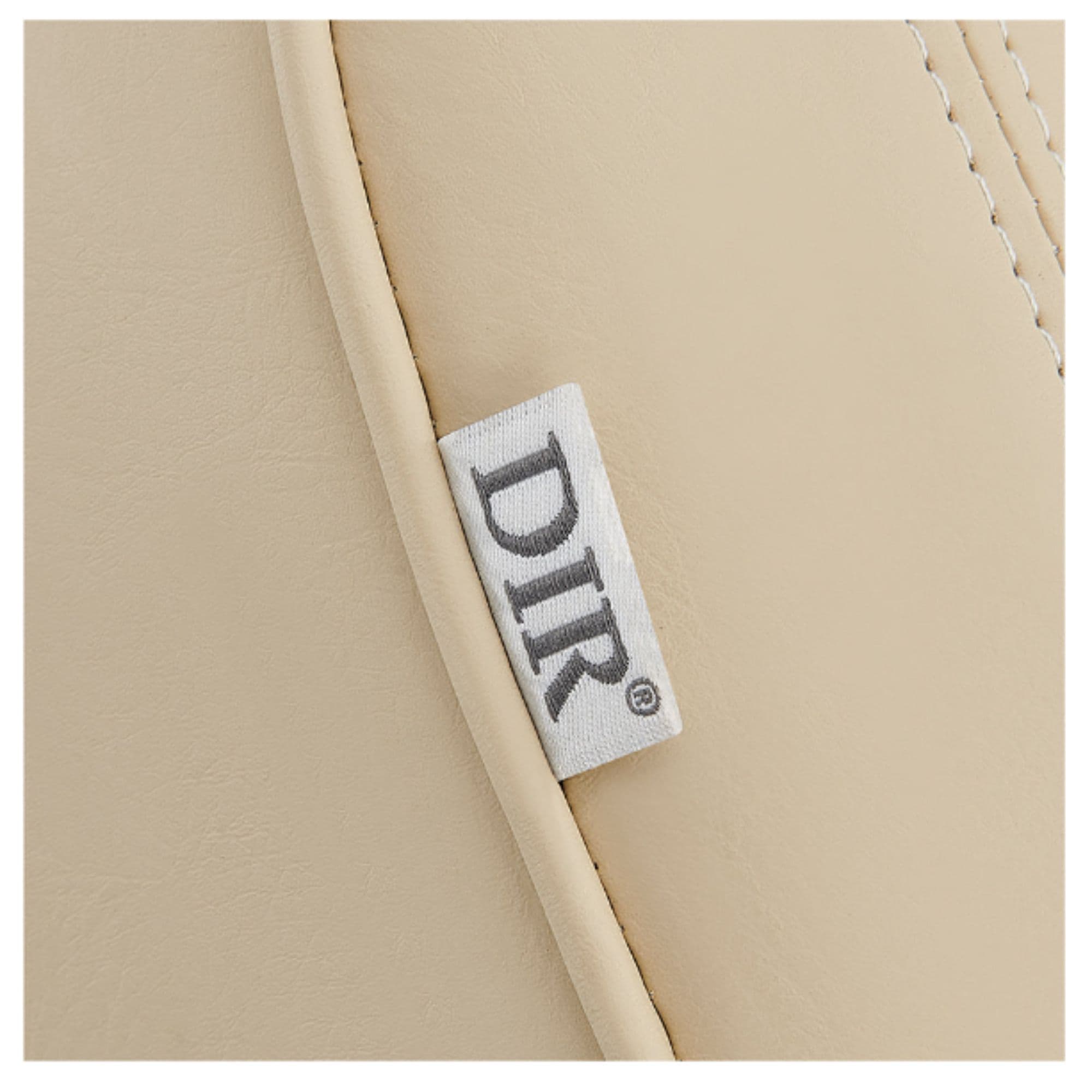 Maximus Spa Reclining Shampoo Bed with Rotating Seat Close-Up View Of Beige Upholstery With Brand Name