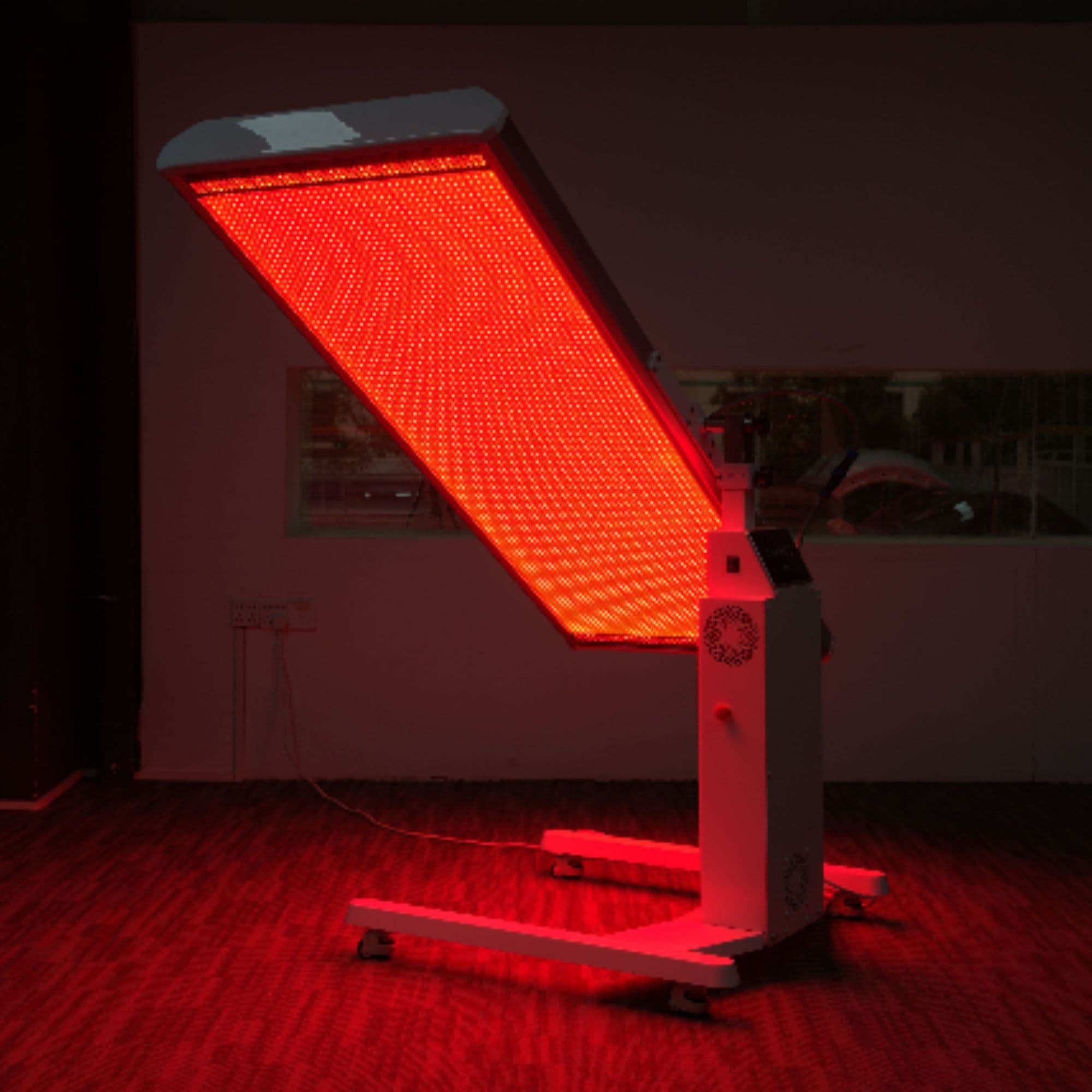 Merican M2N Red Light Therapy Panel Angled Position Operated In Dark Room