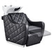 Minervah Massage Backwash Unit Black Front Angled View Of Single Shampoo Wash Station With Blurred Leg Rest Demonstration