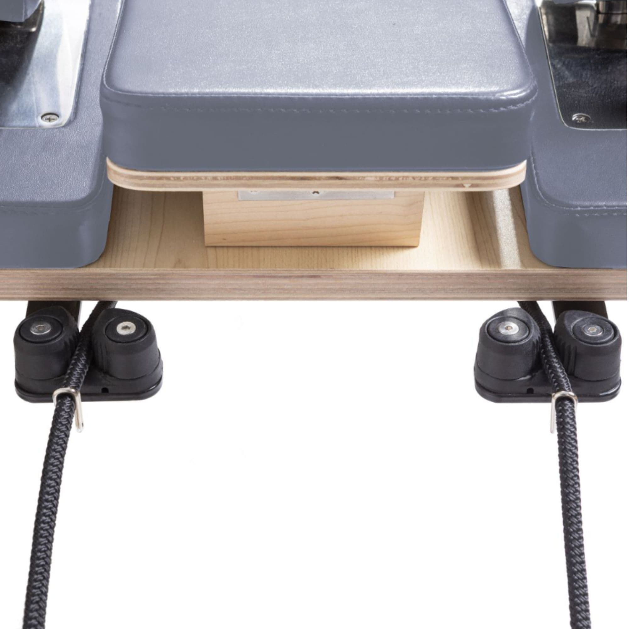 Physio Reformer Master Instructor Close-Up View Of Reformer Rope Guide Pulleys On White Background