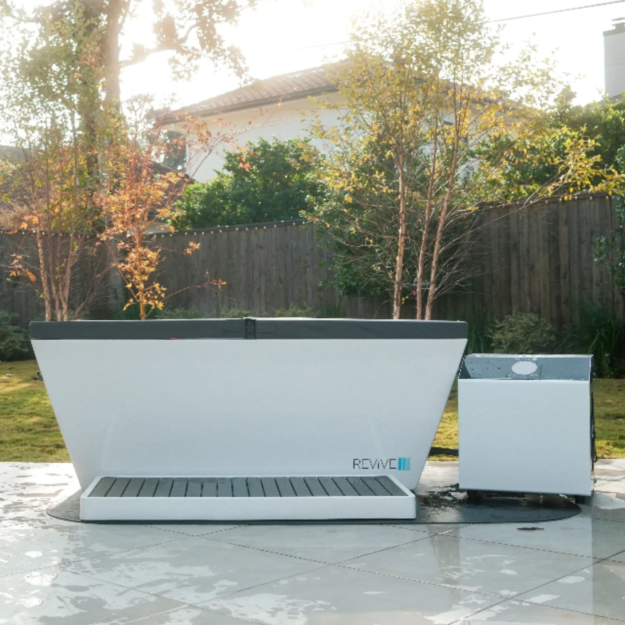 Revive Acrylic Cold Plunge Complete Set Front View Covered In Backyard Setting With Wooden Fence And Trees