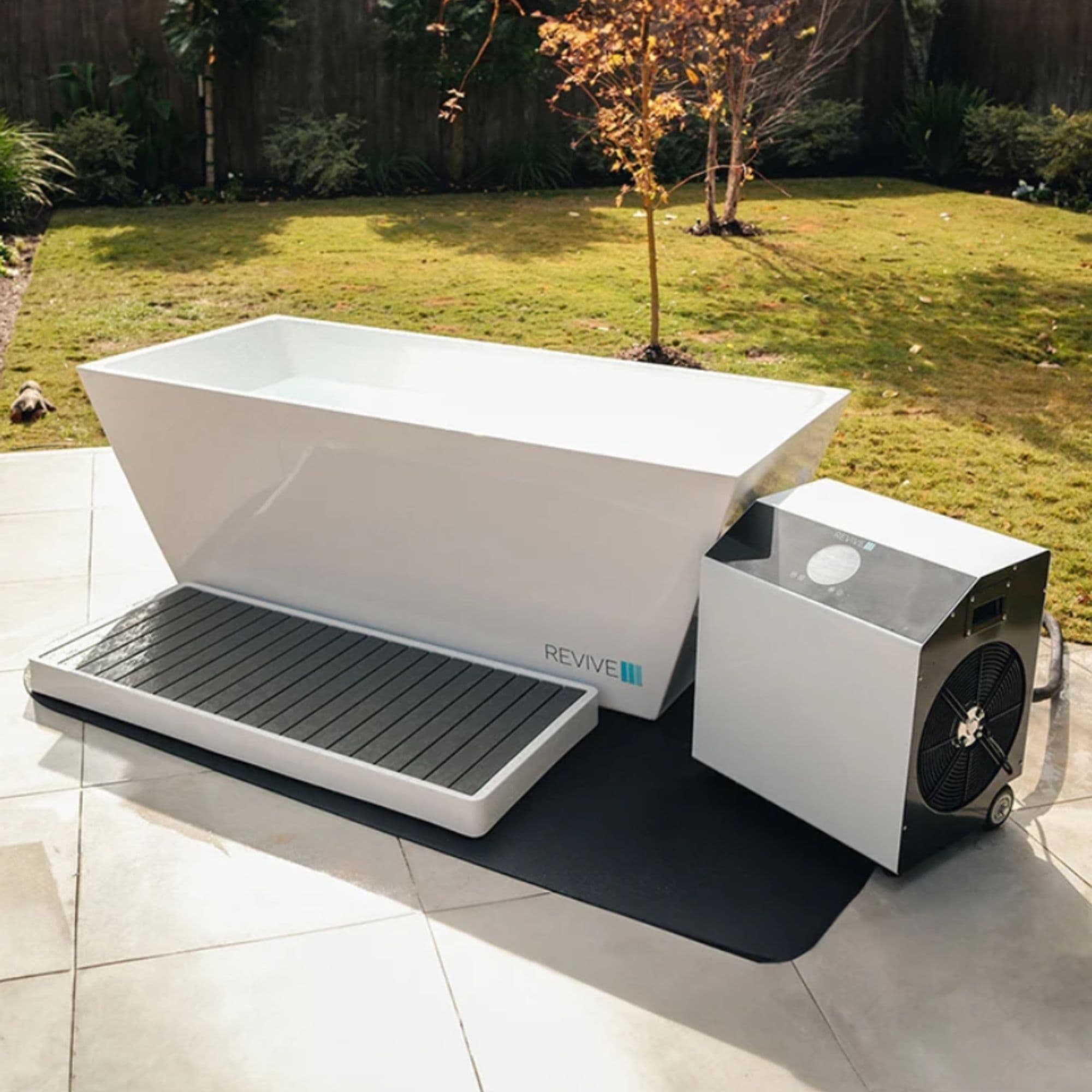 Revive Acrylic Cold Plunge With 1HP Chiller Front Angle View In Backyard Setting With Plants