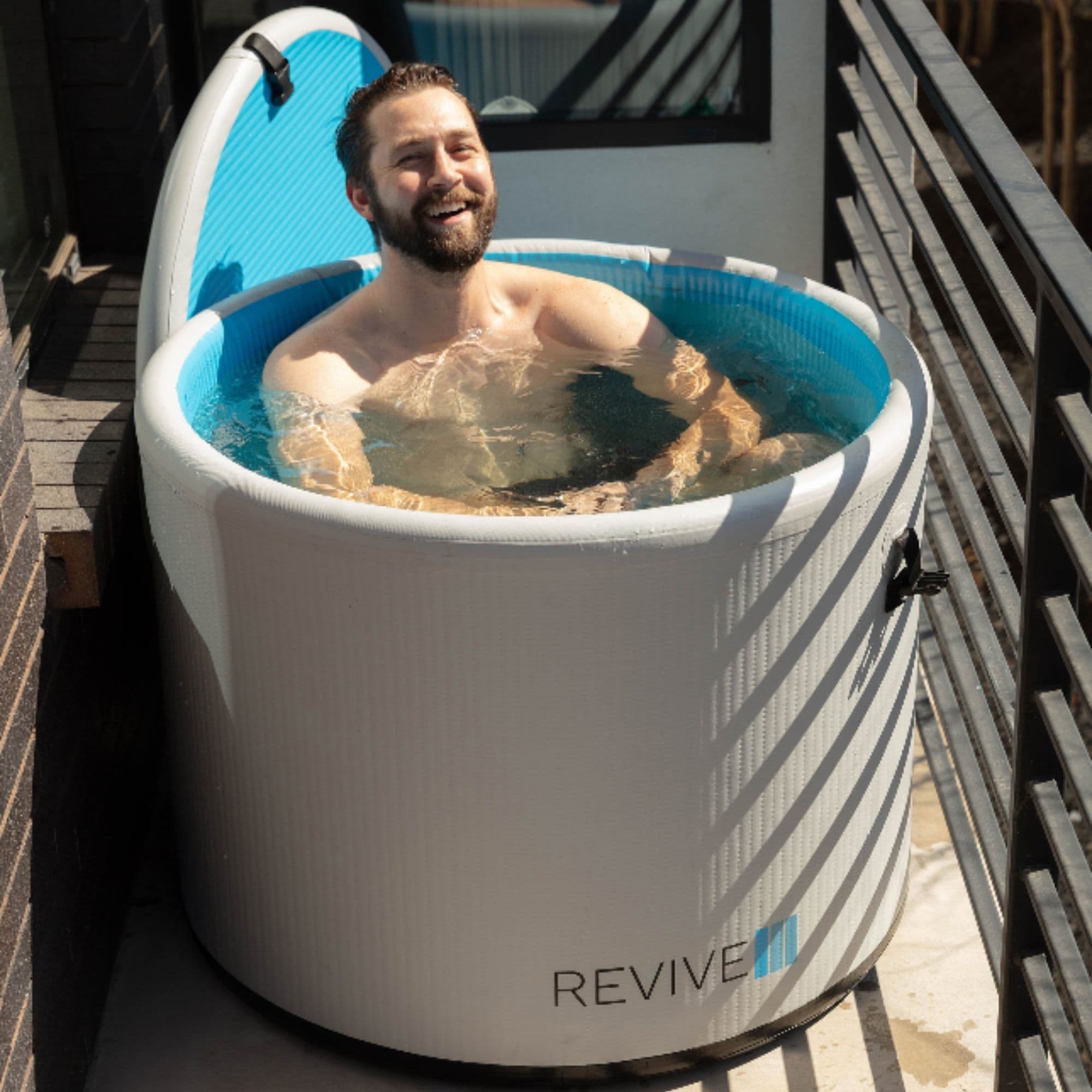 Revive Compact Inflatable Ice Bath Pod Man Enjoying The Cool Immersion In Outdoor Setting