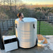 Revive Inflatable Hot And Cold Barrel Plunge With Man Enjoying Cold Water Immersion In Modern Balcony