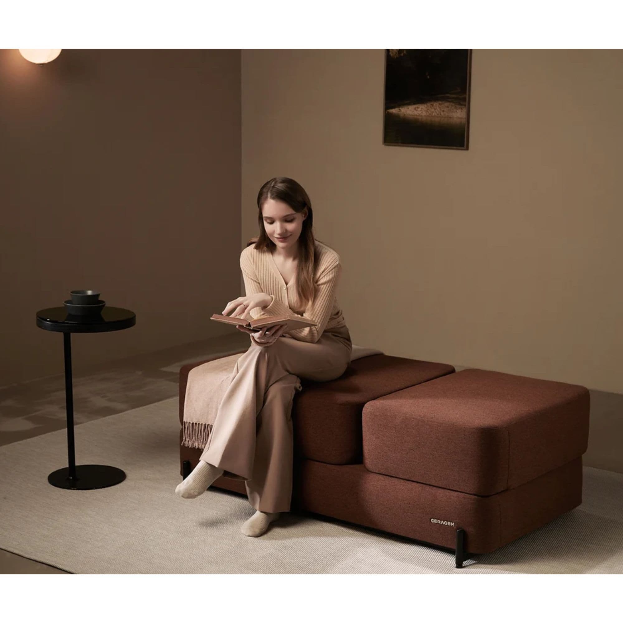 S4 Massage Lounger By Ceragem Brown Variant With Woman Relaxing While Reading Book In Sofa Mode
