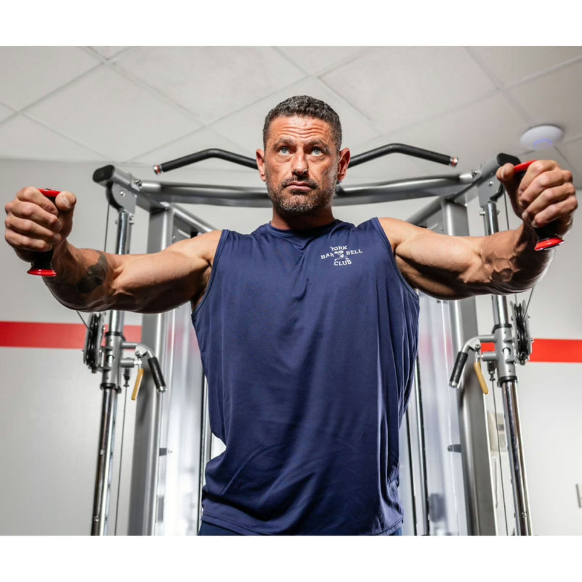 STS Functional Cable Crossover Front View With A Man Performing A Chest Fly Exercise