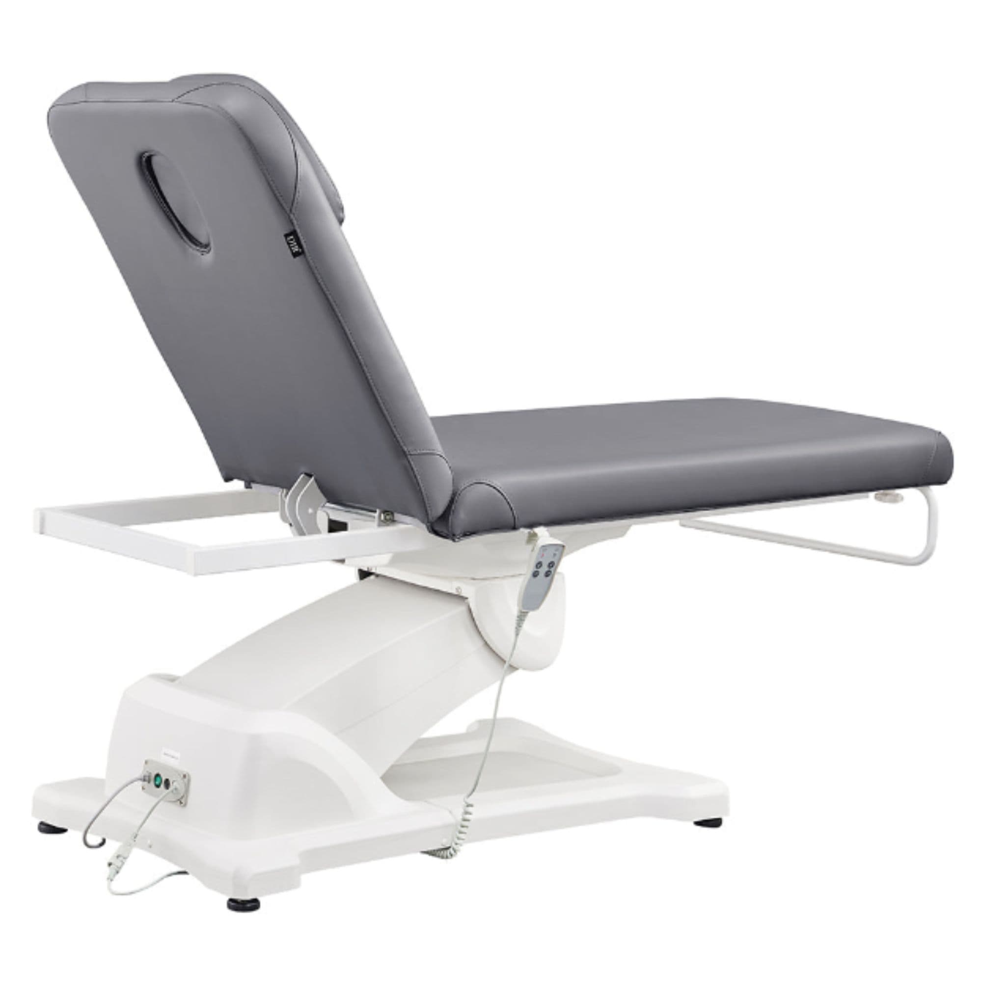 Serenity Electric Treatment Table Rear View Of Gray Color And Reclined On Head Section With Remote Control On White Background