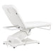 Serenity Electric Treatment Table Rear View Of White Color And Reclined On Head Section With Remote Control On White Background
