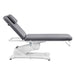 Serenity Electric Treatment Table Side View Of Gray Color With Remote Control On White Background