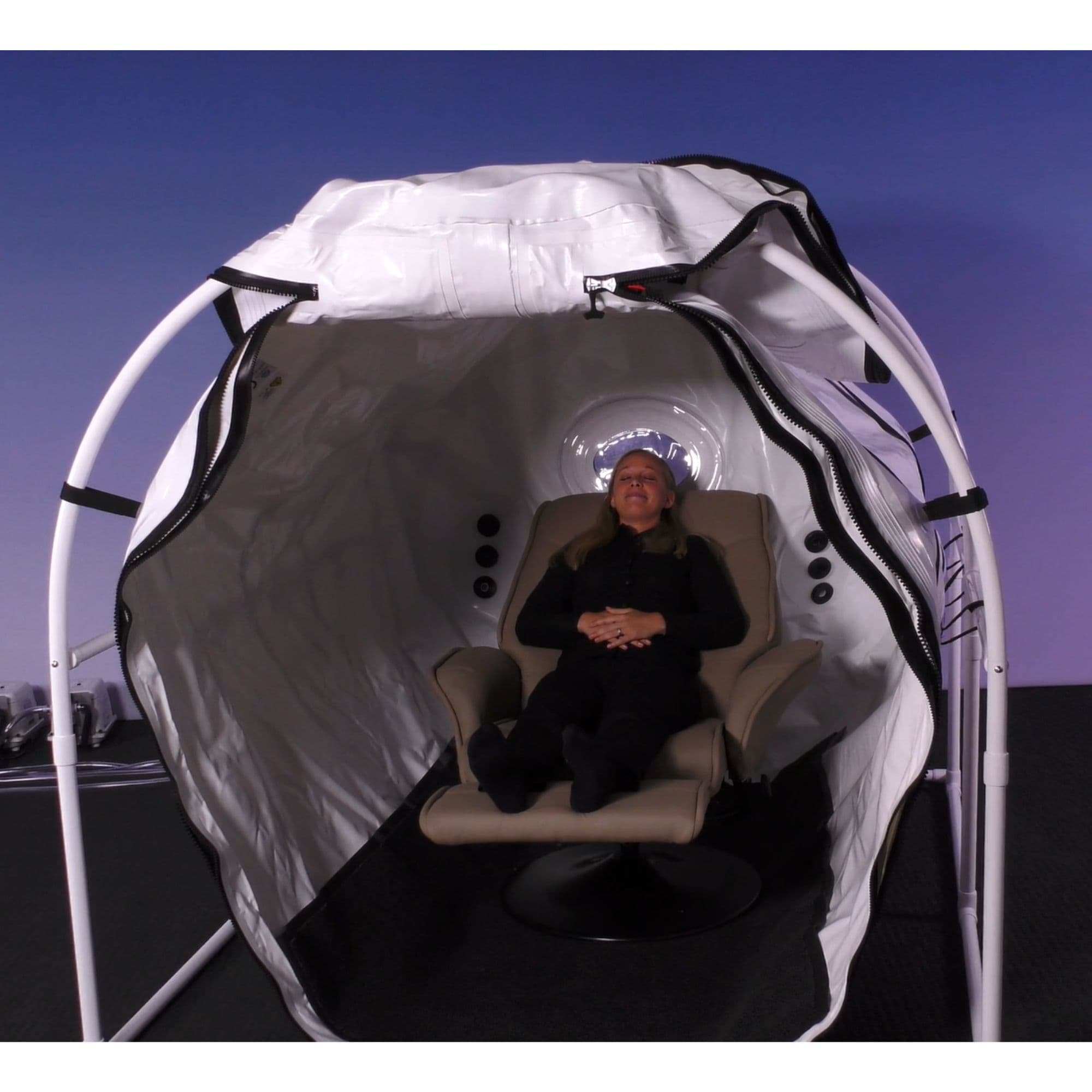 Summit to Sea 60-Inch Mild Hyperbaric Chamber Front View With Woman Relaxing On Recline Chair Inside