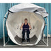 Summit to Sea Spacious Multi-Person Hyperbaric Chamber Front View With Woman Using Exercise Equipment Inside