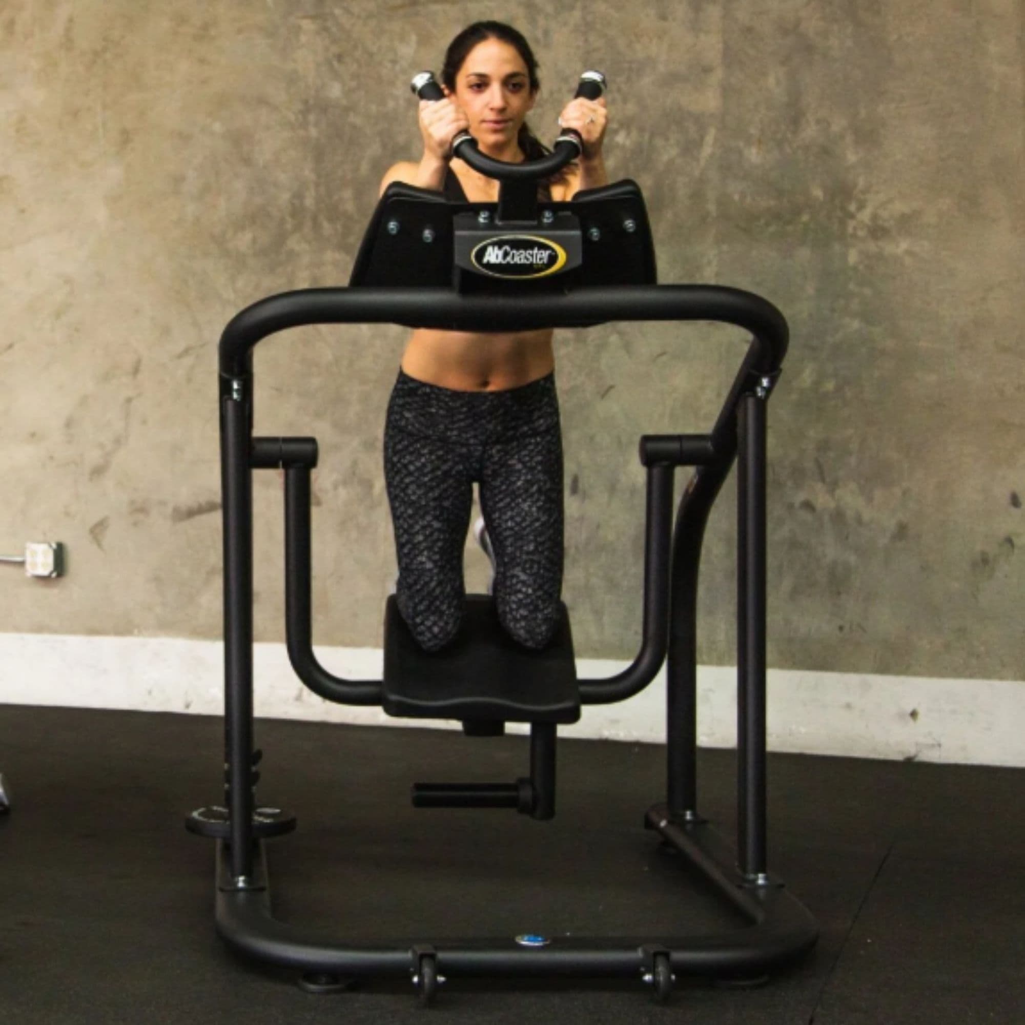 The Abs Company Ab Coaster CTL – ABS1001B Front View Of Woman Performing A Core Exercise On Gym Setting