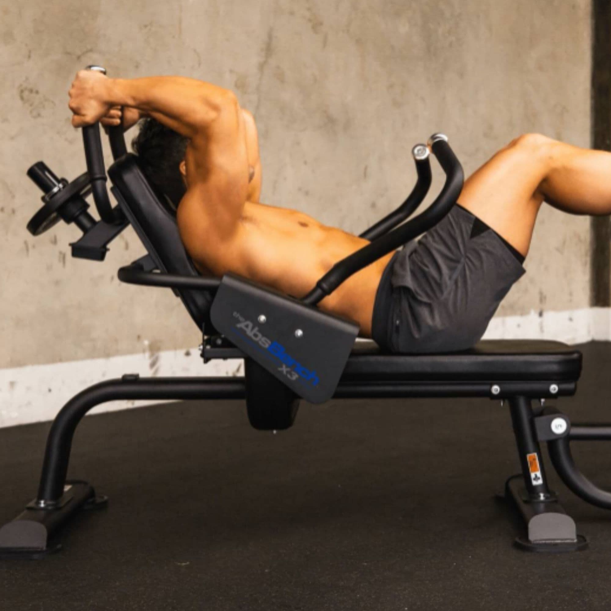 The Abs Company Abs Bench X3 – ABS1014B Side View Of A Man Performing A Weighted Crunch Exercise