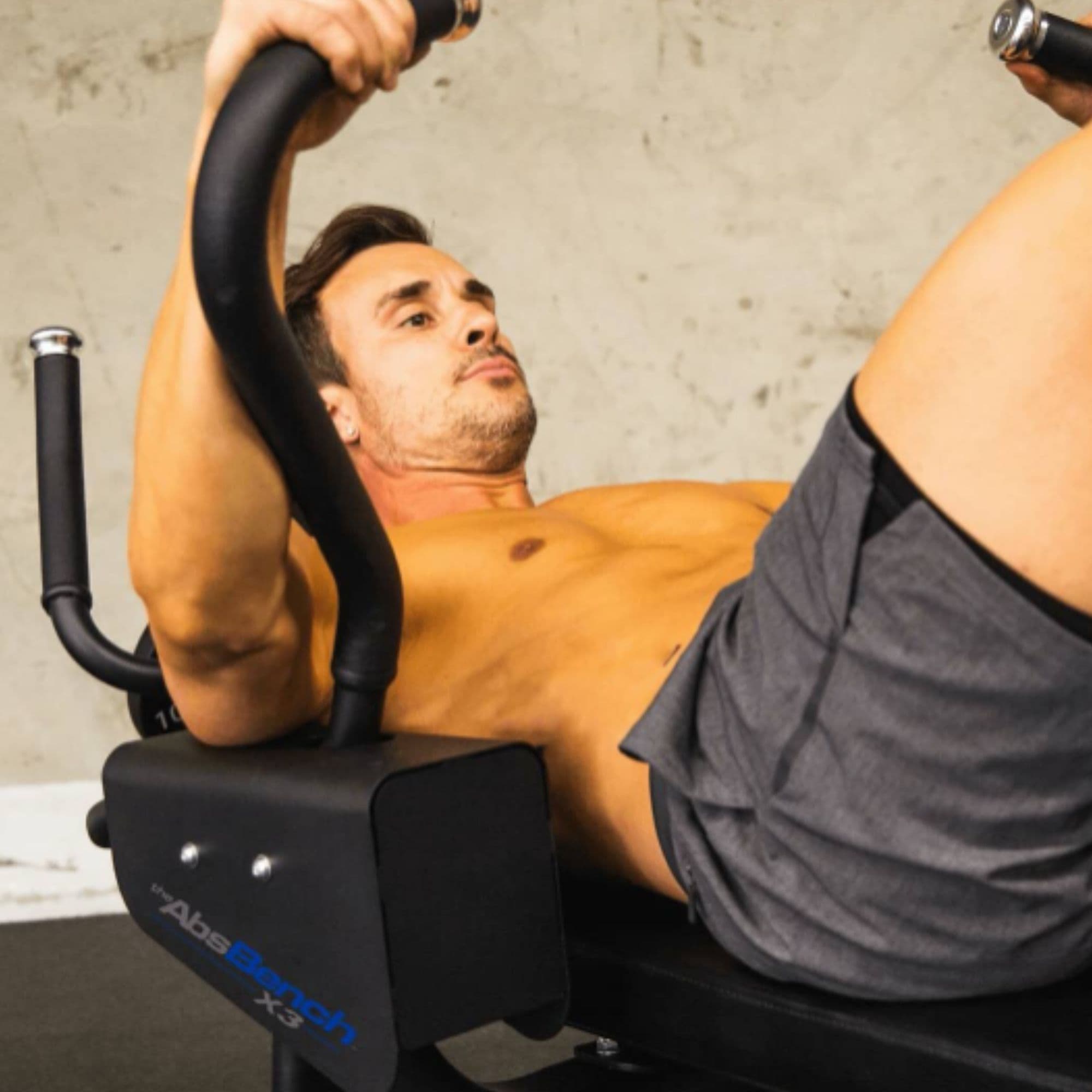 The Abs Company Abs Bench X3 – ABS1014B With A Close-Up View Of A Man Performing A Core Training