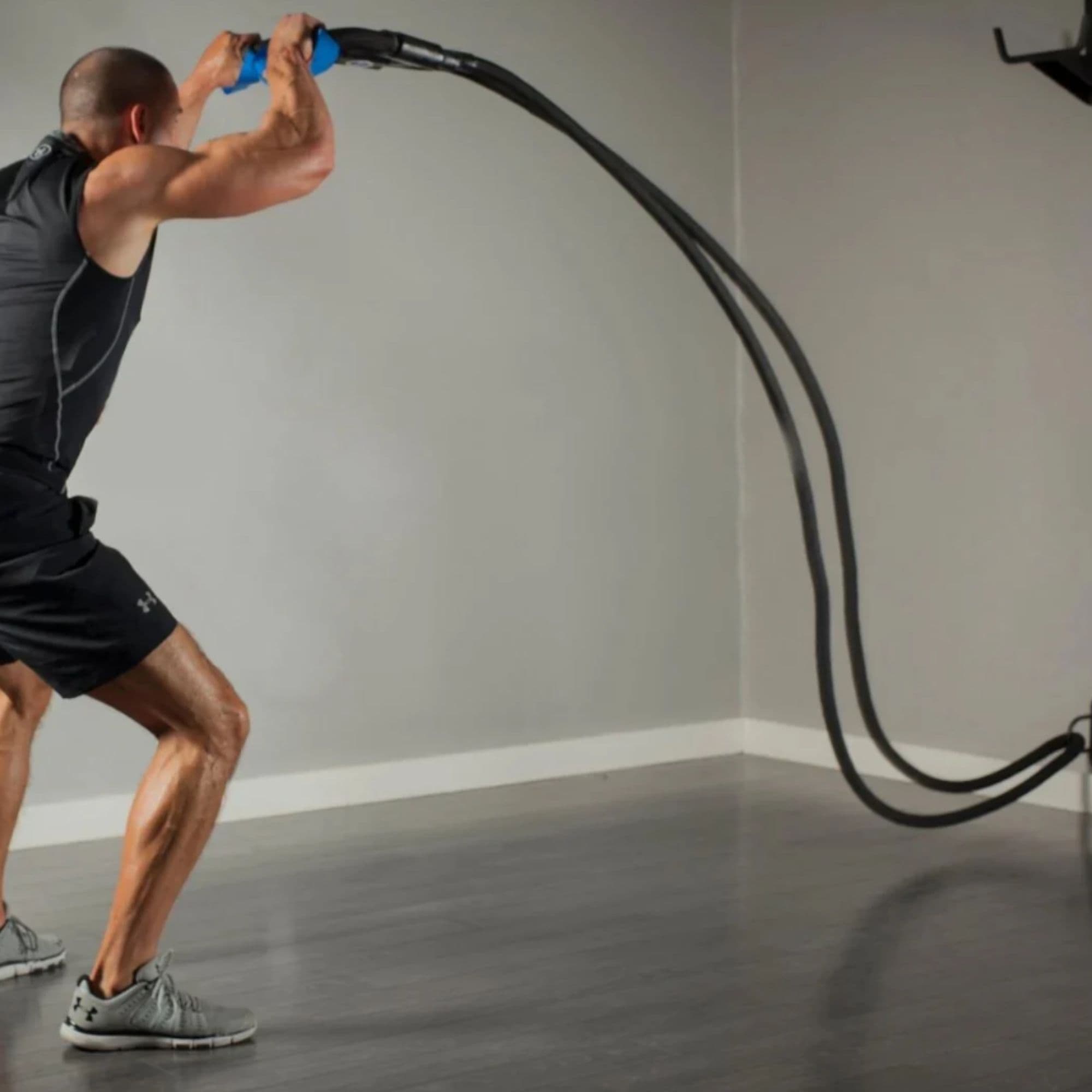 The Abs Company Battle Rope ST System – ABS3024 With A Man Performing A Dynamic Resistance Band Exercise