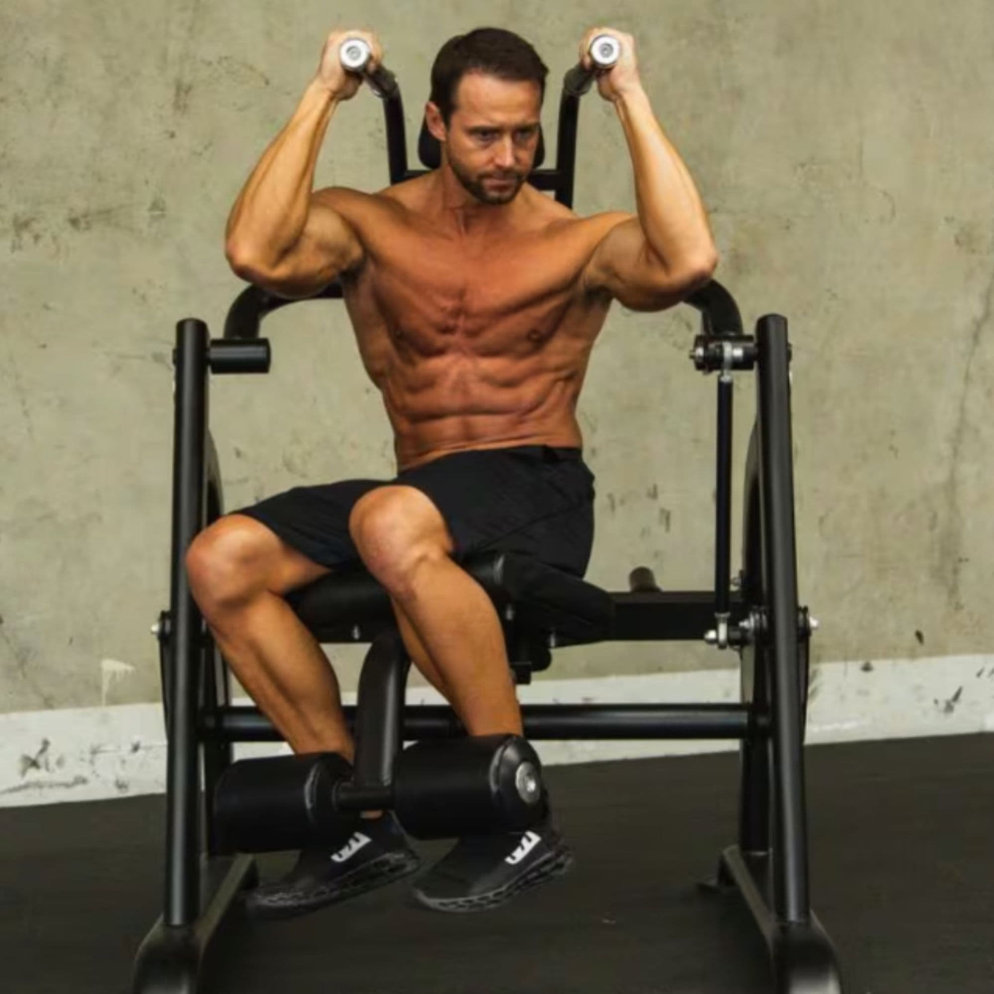 The Abs Company Four-Piece Core And Glute Package With A Man Performing A Crunch Workout On Gym Setting