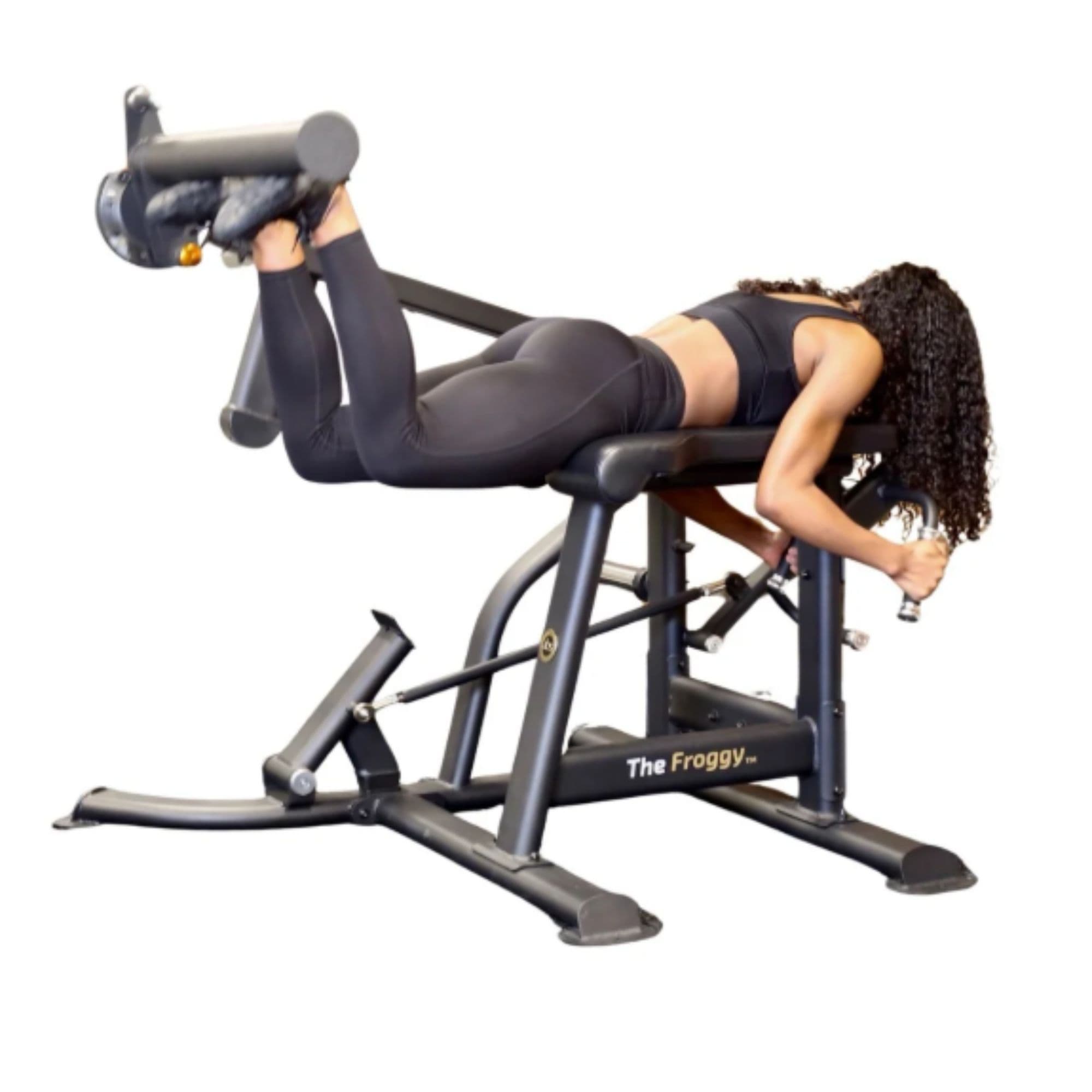 The Abs Company The Froggy Glute Bench With A Woman Performing A Prone Leg Curl On White Background