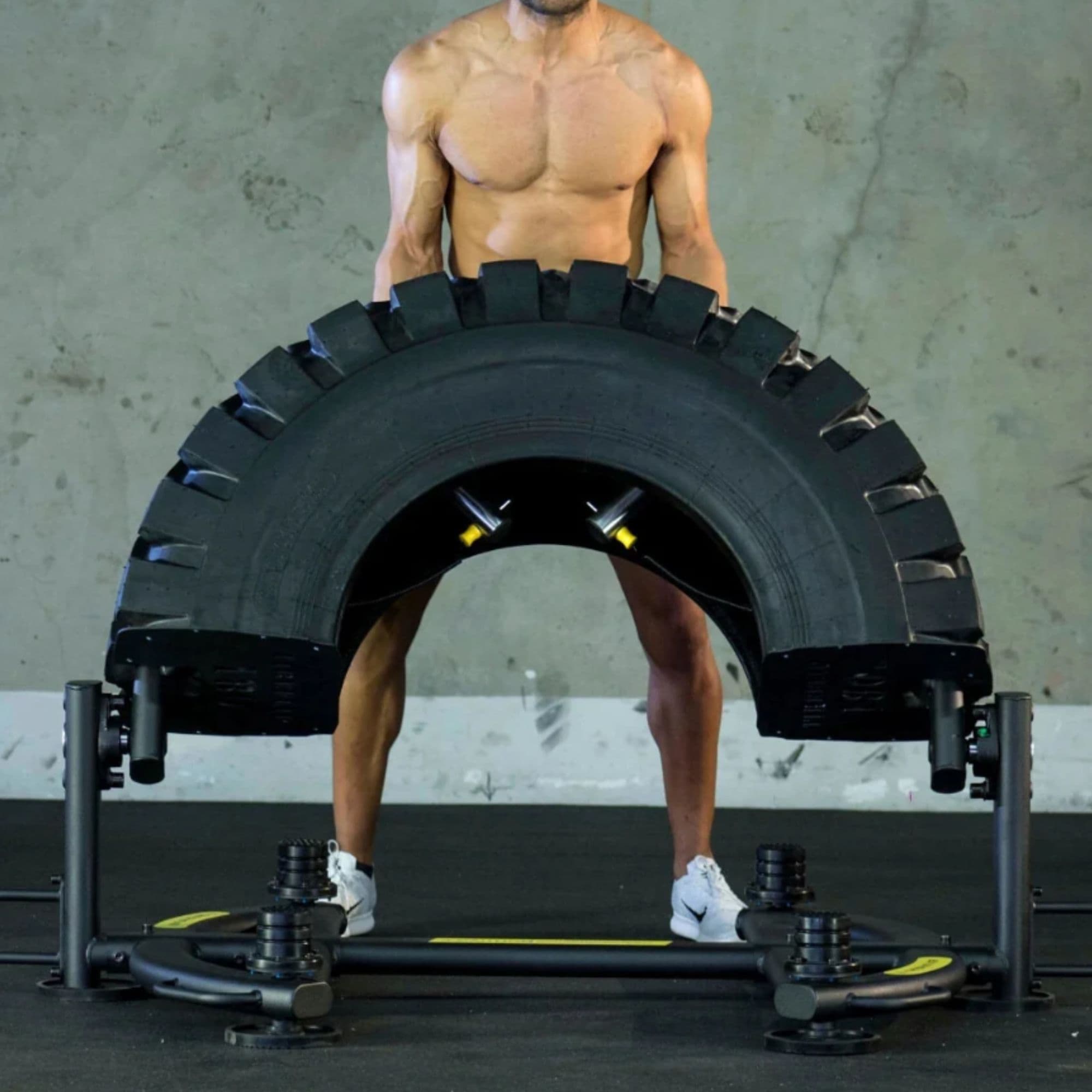 The Abs Company TireFlip 180 Tire Flip Machine – ABS4004-02 With A Man Demonstrating A Flip