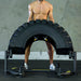 The Abs Company TireFlip 180 Tire Flip Machine – ABS4004-02 With A Man Demonstrating A Flip