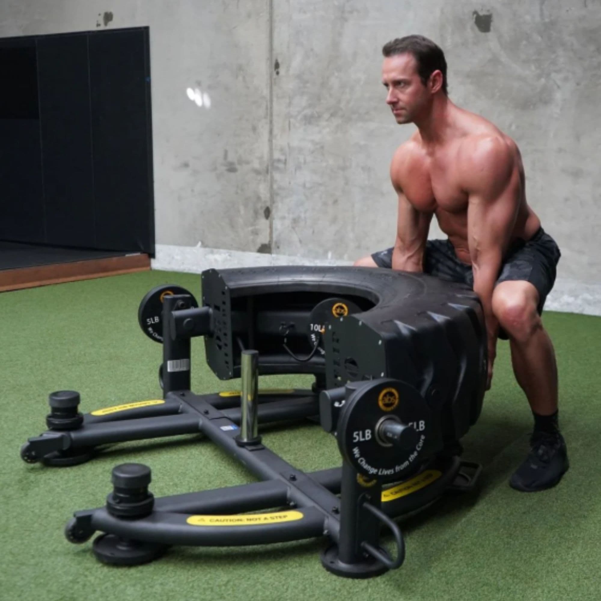 The Abs Company TireFlip 180 With A Man Performing A Tire Flip Exercise