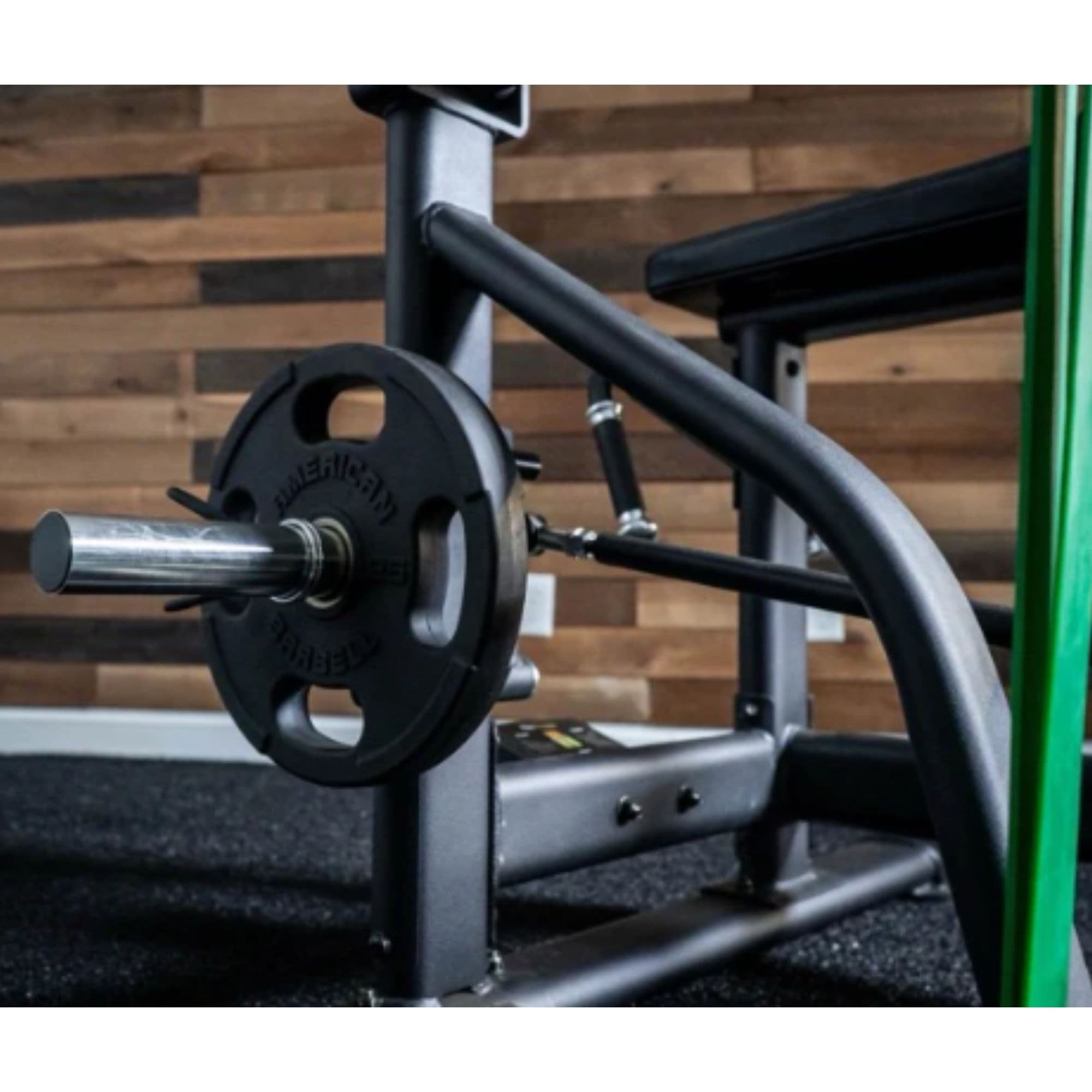 The Froggy Glute Bench Close-Up View Of Plate-Loading System On Wooden Background