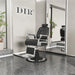 Titan Hydraulic Barber Chair Black Variant Front Angled View With Tall Mirror And Brand Name In The Background