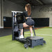 Total Glute Machine By The Abs Company With A Woman Performing A Standing Hip Abduction Exercise On A Gym Setting
