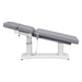 Tranquility 4-Motors Electric Medical Spa Treatment Table Side View Of Gray Variant Fully Reclined Chair And Raised Head Section With Remote Control On White Background