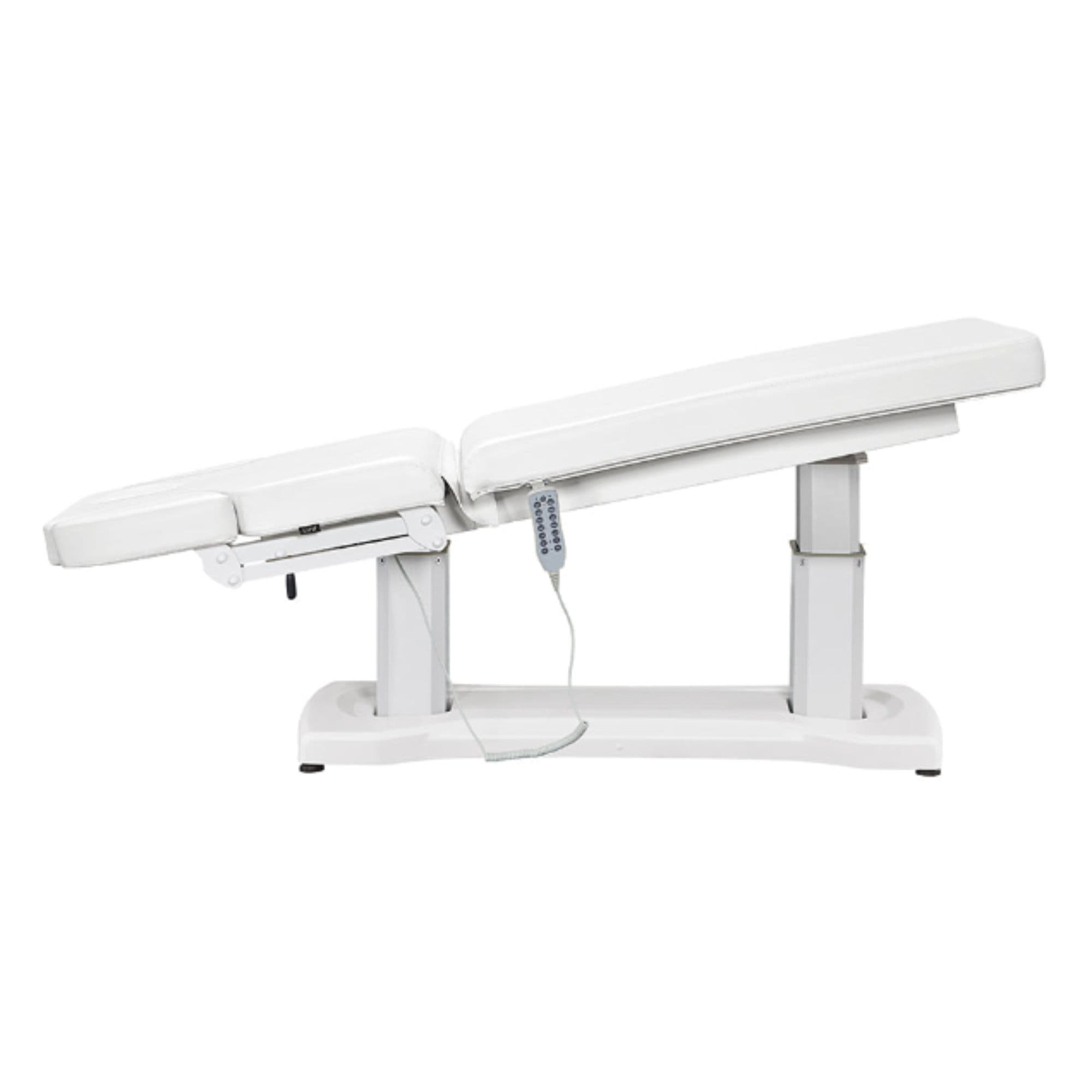 Tranquility 4-Motors Electric Medical Spa Treatment Table Side View Of White Variant Fully Reclined Chair With Raised Leg Section And Remote Control On White Background